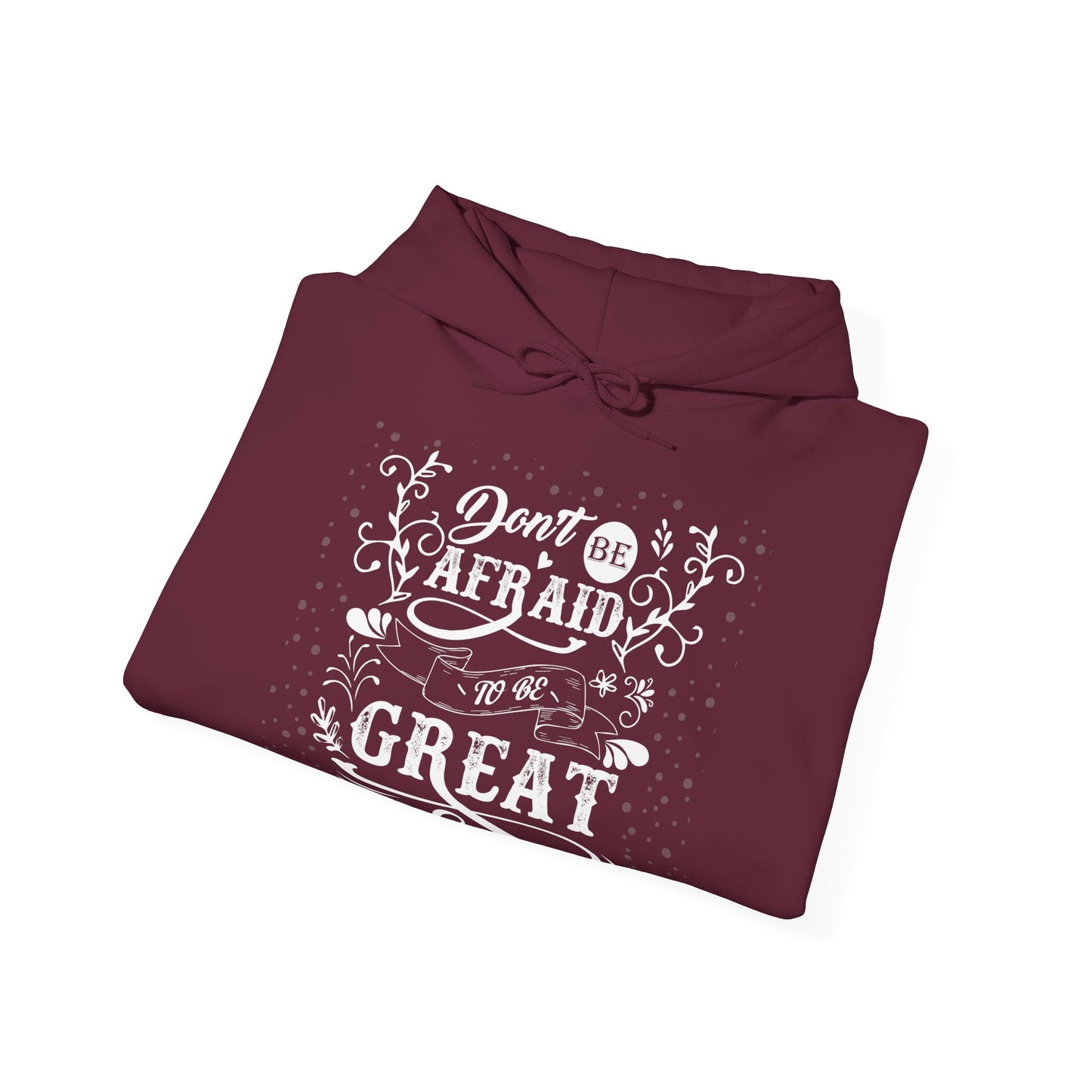 A folded maroon unisex hooded sweatshirt with the text 'DON'T BE AFRAID TO BE GREAT' printed on the front.