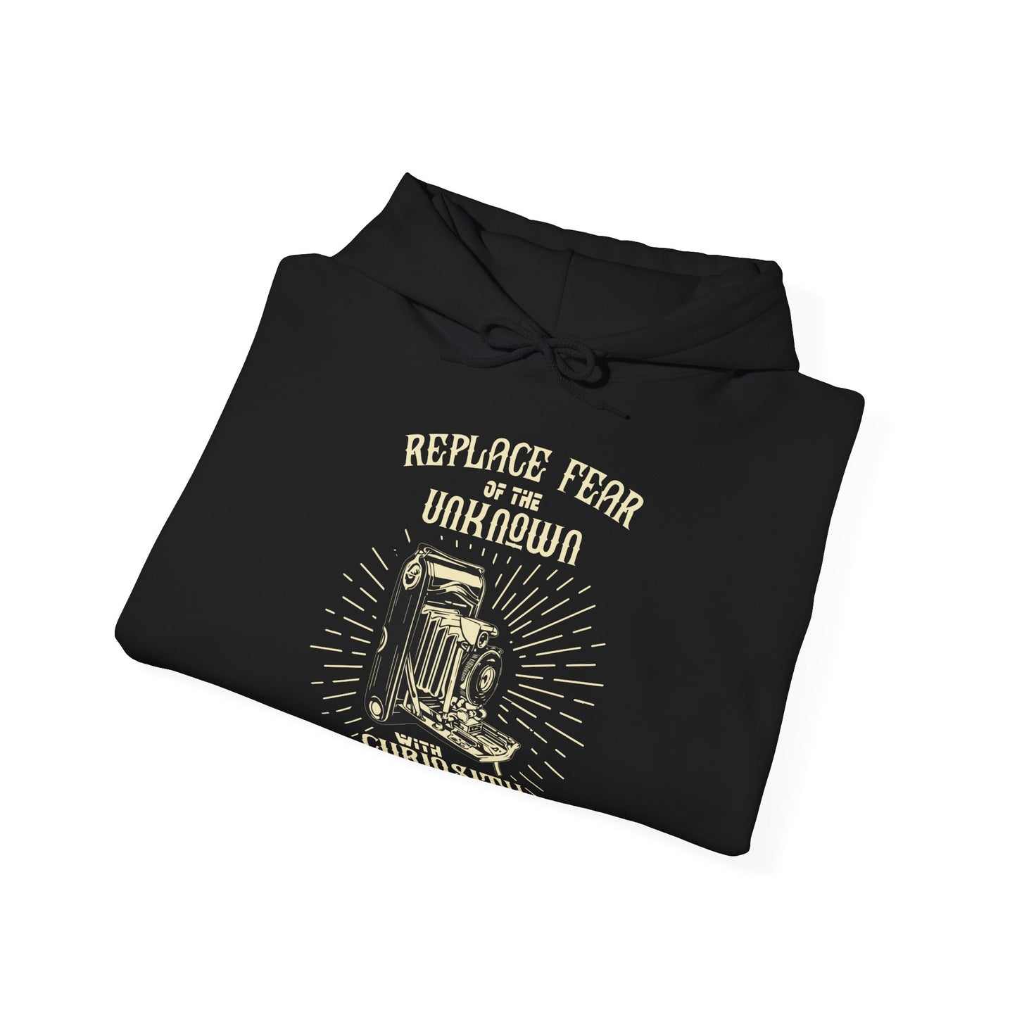 A folded black unisex hooded sweatshirt with 'REPLACE FEAR OF THE UNKNOWN WITH CURIOSITY' printed on the front.