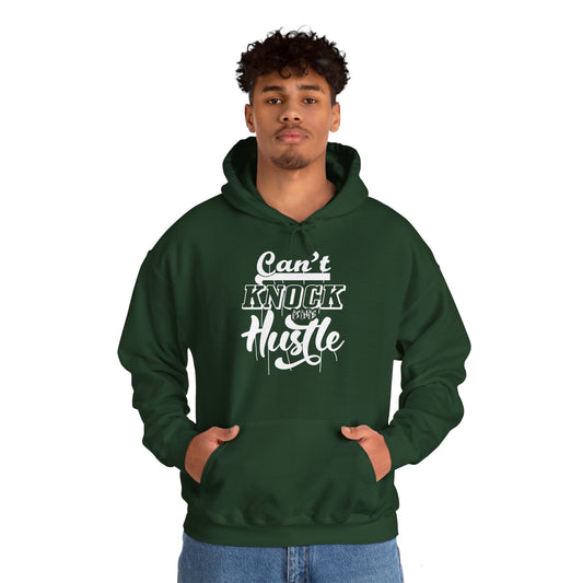 A person wearing a green unisex hooded sweatshirt with 'Can't Knock The Hustle' text design.