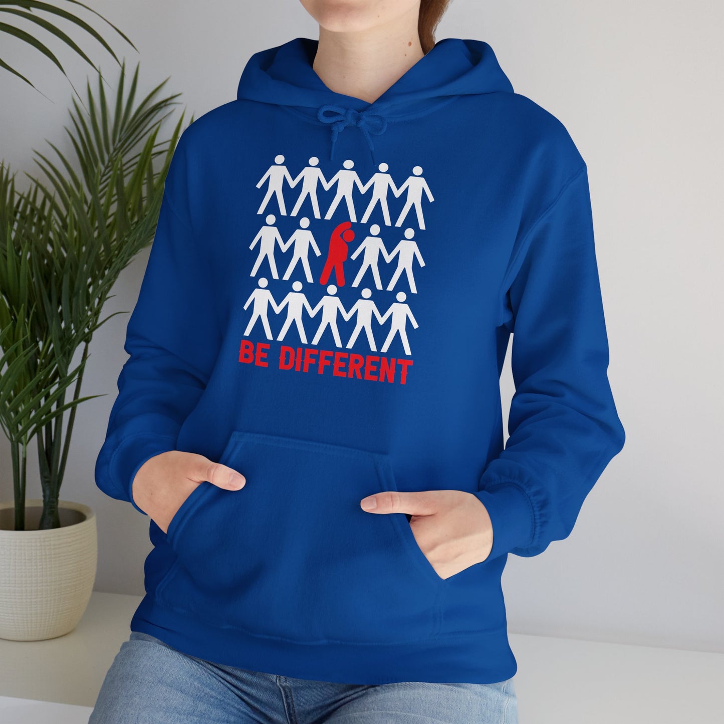 A person wearing a blue hooded sweatshirt with 'BE DIFFERENT' text and a graphic design on the front.