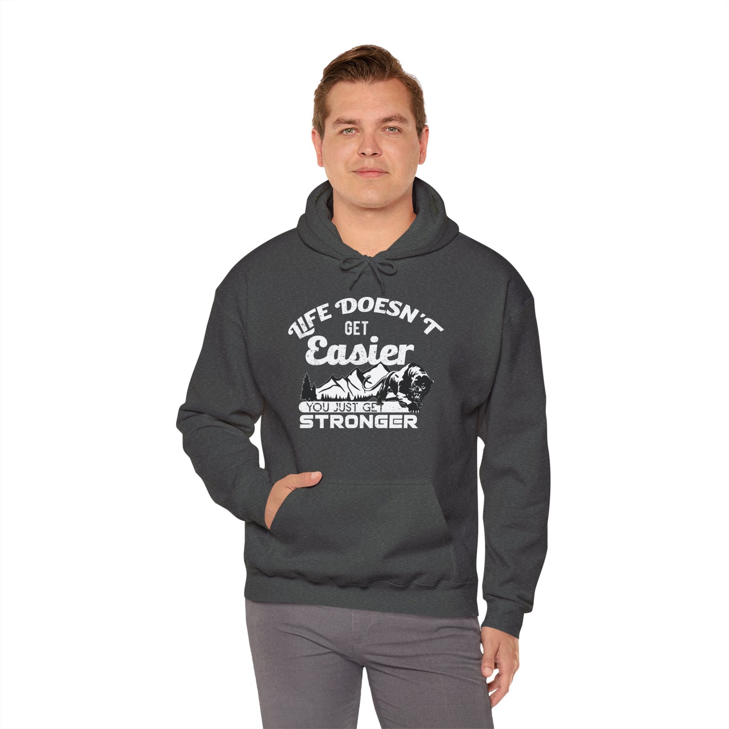 Person wearing a dark heather unisex hooded sweatshirt with the text 'LIFE DOESN'T GET EASIER YOU JUST GET STRONGER' printed on the front.