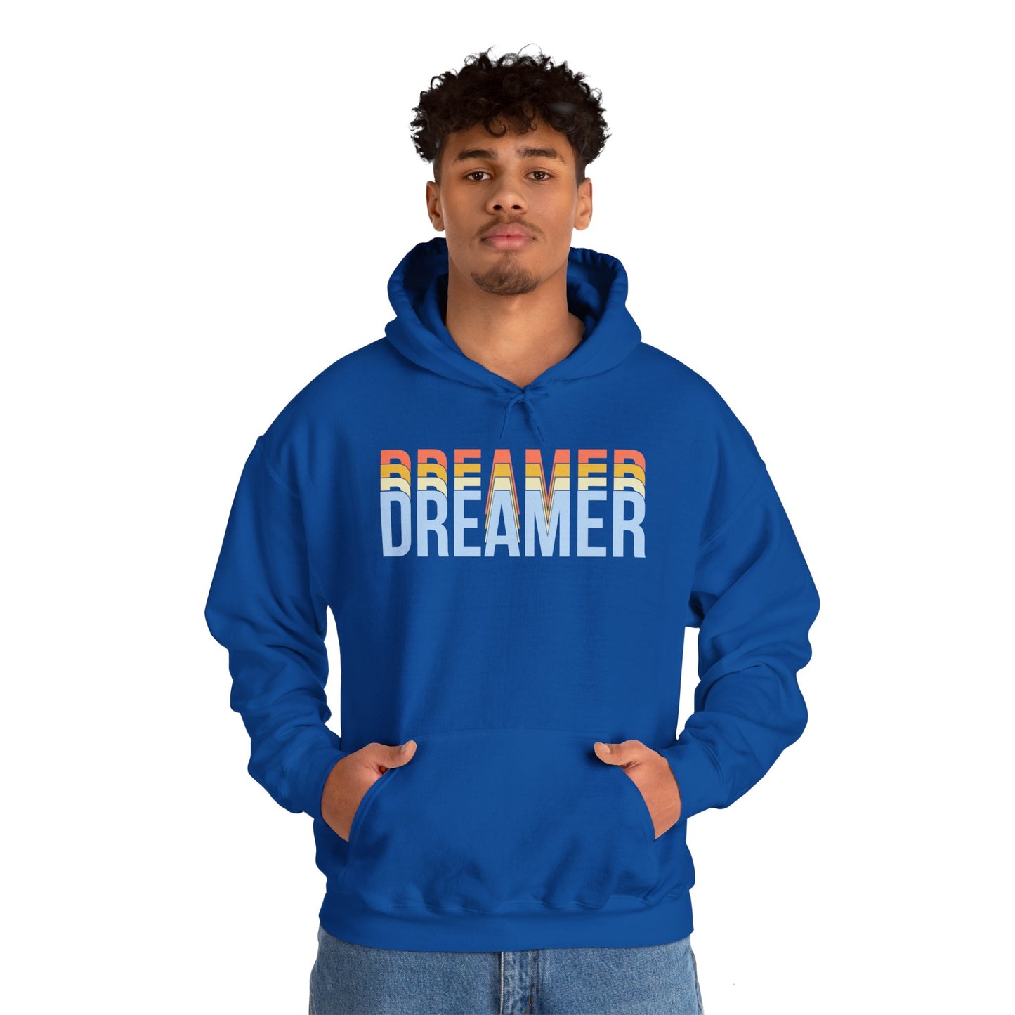A person wearing a blue unisex hooded sweatshirt with 'DREAMER' text in white and blue gradient on the front.