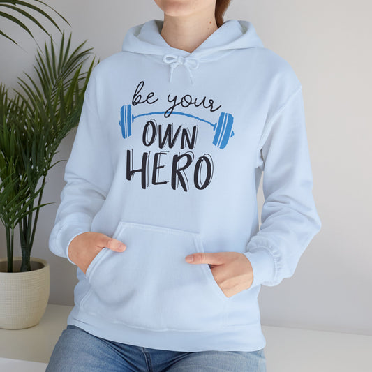 A person wearing a blue unisex hooded sweatshirt with 'BE YOUR OWN HERO' text and a weight lifting symbol on the front.