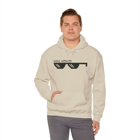A male model wearing a beige unisex hooded sweatshirt with 'DEAL WITH IT' text and sunglasses design on the front.