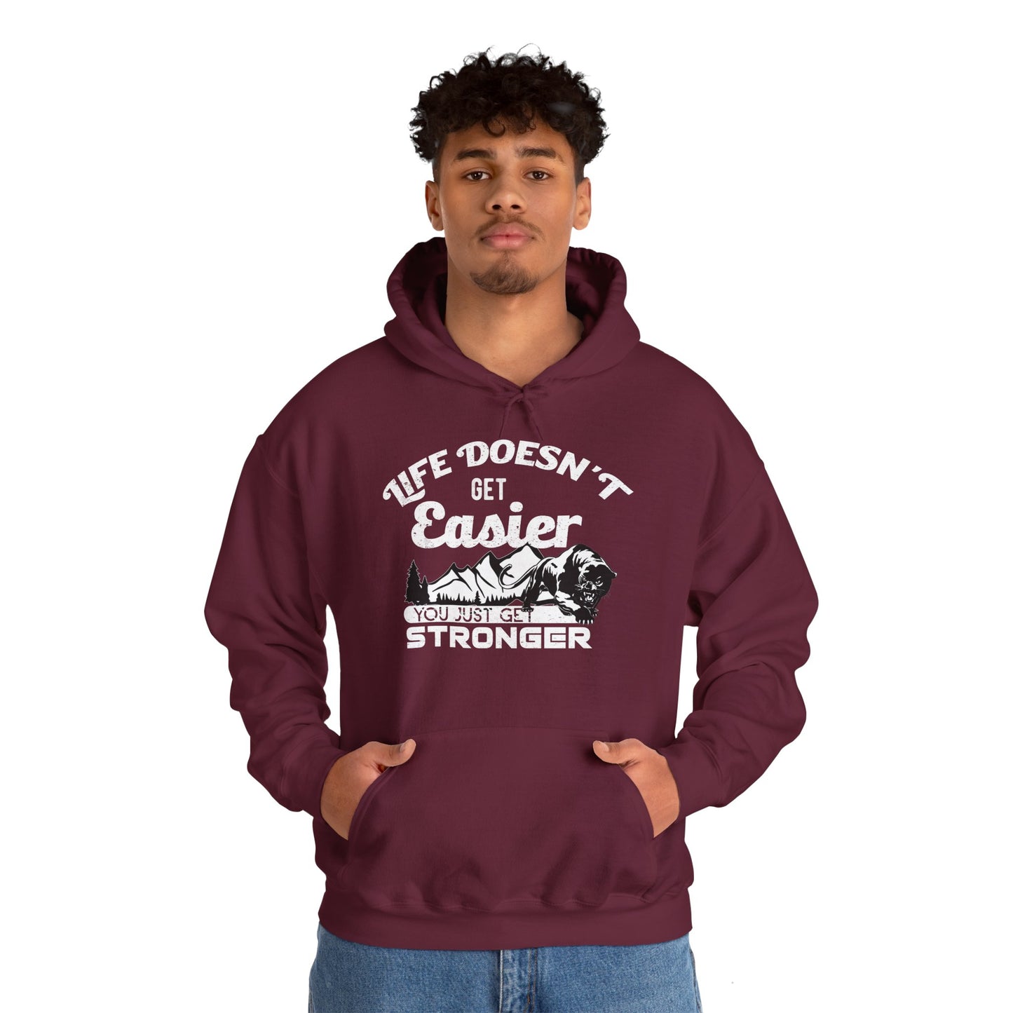 Person wearing a maroon unisex hooded sweatshirt with the text 'LIFE DOESN'T GET EASIER YOU JUST GET STRONGER' printed on the front.