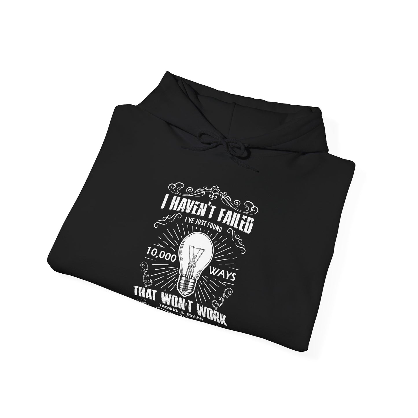 A folded black unisex hooded sweatshirt with a text design on the front stating 'I Haven't Failed, I've just found 10,000 ways that won't work' by Thomas Edison.