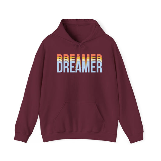 A maroon unisex hooded sweatshirt with 'DREAMER' text in rainbow colors on the front.