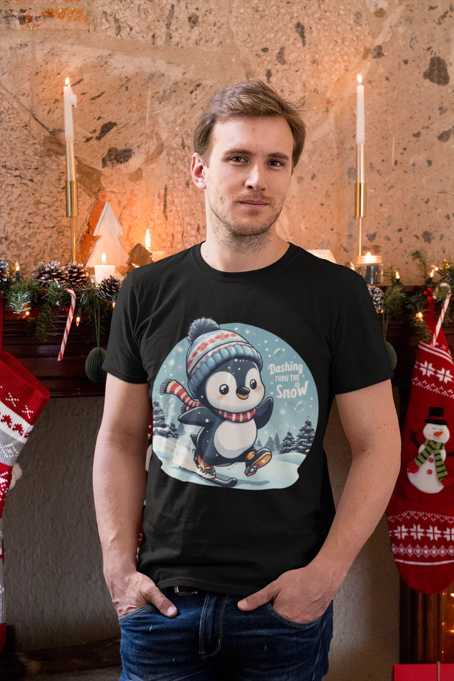 Man standing in a room, wearing a black t-shirt with a design at the front of a penguin skiing and the text 'dashing thru the snow'
