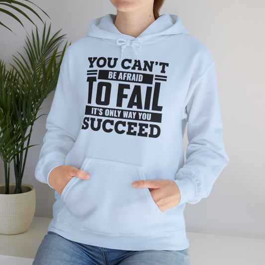 A person wearing a blue hooded sweatshirt with the text 'You Can't Be Afraid To FAIL It's Only Way You Can SUCCESS' printed on the front.