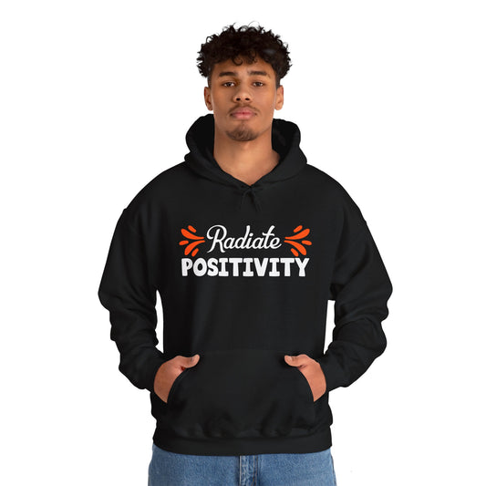 A person wearing a black unisex hooded sweatshirt with 'Radiate Positivity' text on the front.