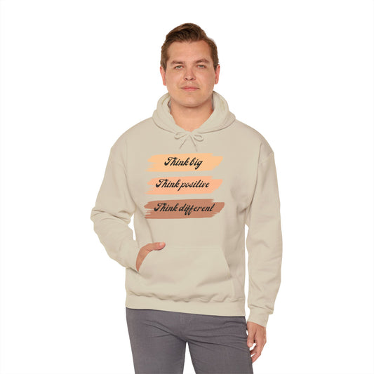 A male model wearing a beige unisex hooded sweatshirt with the text 'THINK BIG THINK POSITIVE THINK DIFFERENT' printed on the front.