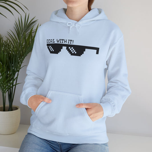 A person wearing a blue unisex hooded sweatshirt with 'DEAL WITH IT' text and sunglasses design on the front.